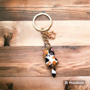 Cat charm.  Calico with frown